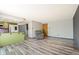 Open living space with wood-look flooring, comfortable armchair, and access to the kitchen area at 4860 E 120Th Pl, Thornton, CO 80241