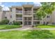 Beige condominium building with well-manicured lawn and stairs leading to upper units at 20 S Boulder Cir # 2109, Boulder, CO 80303