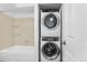 This laundry area has a stacked washer and dryer, next to the shower at 20 S Boulder Cir # 2109, Boulder, CO 80303