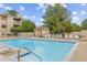 Enjoy the community pool surrounded by lounge chairs, greenery and building at 20 S Boulder Cir # 2109, Boulder, CO 80303