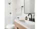 Modern bathroom featuring a shower, light wood vanity, matte black finishes, and mirror at 13202 Olmsted Pl, Denver, CO 80239