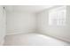 Bedroom with neutral carpet, white walls, and a bright window for natural light at 13202 Olmsted Pl, Denver, CO 80239