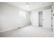Bright bedroom with a ceiling fan, ample closet space, and a large window at 13202 Olmsted Pl, Denver, CO 80239