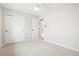 Well-lit bedroom offers a neutral palette, plush carpet, and a spacious closet for comfortable living at 13202 Olmsted Pl, Denver, CO 80239
