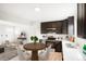 Eat-in kitchen features stainless steel appliances, white countertops, and dark cabinetry at 13202 Olmsted Pl, Denver, CO 80239
