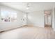 Sunlit living room with wood floors, white walls, and a view of the front yard at 13202 Olmsted Pl, Denver, CO 80239