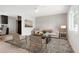 Bright living room features modern decor, light wood floors, and lots of natural light at 13202 Olmsted Pl, Denver, CO 80239
