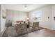 Living room with panelled wall, modern decor, and natural light from the large window at 13202 Olmsted Pl, Denver, CO 80239