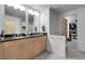 Modern bathroom featuring double sinks, granite countertops, and a view to the walk-in closet at 2229 Blake St # 505, Denver, CO 80205