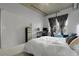 Comfortable bedroom featuring a large window, desk, chair, and a queen sized bed at 2229 Blake St # 505, Denver, CO 80205