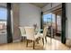 Dining area with a glass table, four chairs, and a sliding glass door to the balcony at 2229 Blake St # 505, Denver, CO 80205