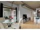 Modern dining room with a glass table, white chairs, and view of an outdoor space at 2229 Blake St # 505, Denver, CO 80205