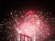 Dynamic display of vibrant red and white fireworks illuminating the night sky at 2229 Blake St # 505, Denver, CO 80205