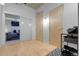 Apartment hallway with hardwood floors and a glimpse into a cozy bedroom at 2229 Blake St # 505, Denver, CO 80205