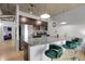 Kitchen with stainless steel refrigerator, breakfast bar with green bar stools, and concrete ceilings at 2229 Blake St # 505, Denver, CO 80205