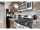 Kitchen with stainless steel appliances, granite countertops, gas range, and modern fixtures at 2229 Blake St # 505, Denver, CO 80205