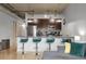Modern kitchen featuring a granite breakfast bar with four stools, and stainless steel appliances at 2229 Blake St # 505, Denver, CO 80205