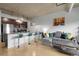 Modern living room featuring a breakfast bar, sleek kitchen, and comfortable gray sectional sofa at 2229 Blake St # 505, Denver, CO 80205