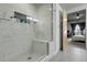 Bathroom shower featuring marble tile, glass door, built-in bench, and access to the primary bedroom at 2229 Blake St # 505, Denver, CO 80205