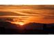 Beautiful sunset with vivid oranges and silhouetted mountains, creating a serene landscape at 2229 Blake St # 505, Denver, CO 80205