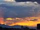 Dramatic sunset over mountain range; clouds glow with vibrant orange and yellow hues at 2229 Blake St # 505, Denver, CO 80205