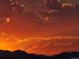 Fiery sunset illuminating the clouds above distant mountains, creating a dramatic scene at 2229 Blake St # 505, Denver, CO 80205