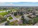 Beautiful aerial shot of a neighborhood and surrounding golf course with trees, ponds, and city skyline views at 5365 W Princeton Dr, Denver, CO 80235