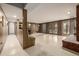 Finished basement with a bar area, brick fireplace, and exterior access through French doors at 5365 W Princeton Dr, Denver, CO 80235