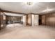 Large finished basement featuring wood paneling, carpet, ping pong table, and ample space at 5365 W Princeton Dr, Denver, CO 80235