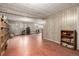Spacious basement featuring white wood paneled walls, red tile flooring, and storage shelves at 5365 W Princeton Dr, Denver, CO 80235