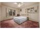 Bright bedroom with a ceiling fan, windows with shutters, and a brass bed frame at 5365 W Princeton Dr, Denver, CO 80235