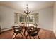 Cozy dining room with traditional table set, large windows offering natural light at 5365 W Princeton Dr, Denver, CO 80235