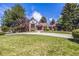 Charming two-story home with well-manicured lawn, mature trees and circular driveway at 5365 W Princeton Dr, Denver, CO 80235