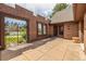 Private outdoor brick patio with wrought iron gate and access to home interior at 5365 W Princeton Dr, Denver, CO 80235