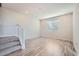 Inviting living room with hardwood floors, a staircase, and a large window at 27752 E 1St Ave, Aurora, CO 80018