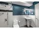 Modern bathroom with white subway tile, pedestal sink, blue accent wall, and rain shower at 705 S Alton Way # 6B, Denver, CO 80247