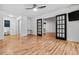 Bright bedroom features a ceiling fan, wood floors, and black french doors at 705 S Alton Way # 6B, Denver, CO 80247