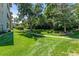 Grassy lawn area with walking path, trees, and building in background at 705 S Alton Way # 6B, Denver, CO 80247