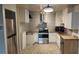Updated kitchen featuring stainless steel appliances, granite countertops, subway tile backsplash and unique flooring at 705 S Alton Way # 6B, Denver, CO 80247
