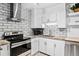 Bright updated kitchen featuring white cabinets, granite countertops, stainless appliances and subway tile backsplash at 705 S Alton Way # 6B, Denver, CO 80247