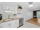Updated kitchen with white cabinets, tile backsplash, stainless appliances, and eat-in area at 705 S Alton Way # 6B, Denver, CO 80247
