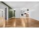 Spacious living room featuring hardwood floors and an open entryway to the updated kitchen at 705 S Alton Way # 6B, Denver, CO 80247