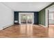 Bright living room featuring beautiful hardwood floors and a sliding glass door to a balcony at 705 S Alton Way # 6B, Denver, CO 80247