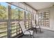 Bright sunroom with large windows, roller shades, and two chairs for relaxing at 705 S Alton Way # 6B, Denver, CO 80247
