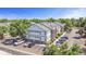 Aerial view of building exterior showing parking, balconies, and surrounding trees at 10784 W 63Rd Pl # 205, Arvada, CO 80004