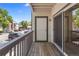 View of the outdoor balcony, with wooden decking, railing, and sliding glass doors at 10784 W 63Rd Pl # 205, Arvada, CO 80004