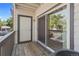 View of the outdoor balcony, with wooden decking, railing, and sliding glass doors at 10784 W 63Rd Pl # 205, Arvada, CO 80004