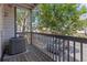 Cozy balcony area with wooden floors, a small air conditioner, and a charming view of the parking lot at 10784 W 63Rd Pl # 205, Arvada, CO 80004