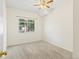 Bright bedroom featuring neutral carpet, ceiling fan, and a window with a pleasant outdoor view at 10784 W 63Rd Pl # 205, Arvada, CO 80004