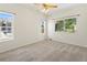 Sunlit bedroom with neutral carpet, ceiling fan, and multiple windows offering pleasant views at 10784 W 63Rd Pl # 205, Arvada, CO 80004